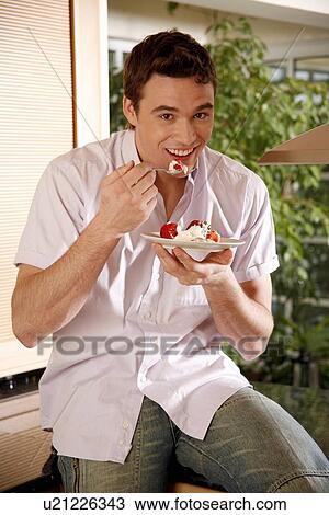 Man eating his breakfast View Large Photo Image Stock Image - Man eating his breakfast. Fotosearch