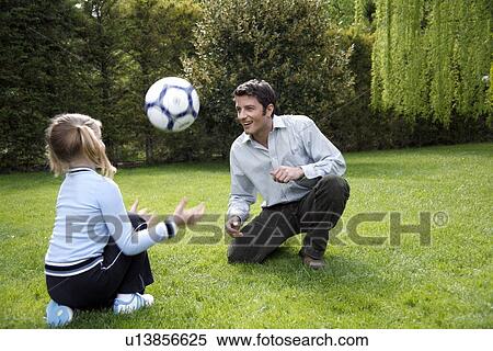 Man teaching girl to play soccer View Large Photo Image Stock Photography - Man teaching girl to play soccer. Fotosearch