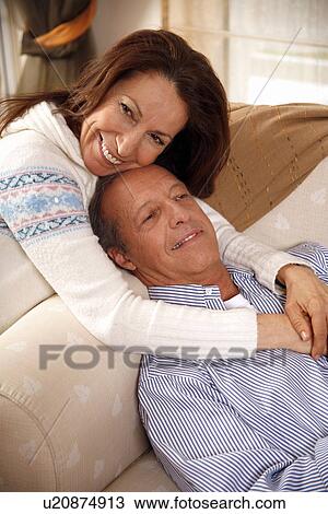 Stock Image - Mature couple relaxing at home. Fotosearch