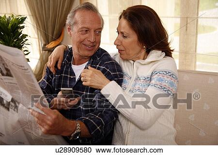 Stock Image - Mature couple relaxing at home. Fotosearch