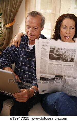Mature couple relaxing at home View Large Photo Image Stock Photography - Mature couple relaxing at home. Fotosearch