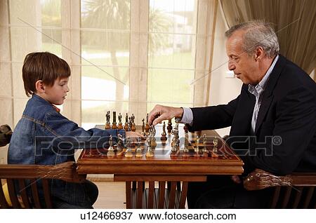 Mature man and little boy playing chess View Large Photo Image Stock Photo - Mature man and little boy playing chess. Fotosearch