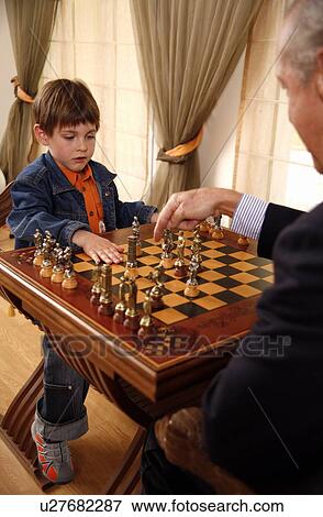 Mature man and little boy playing chess View Large Photo Image Stock Photo - Mature man and little boy playing chess. Fotosearch