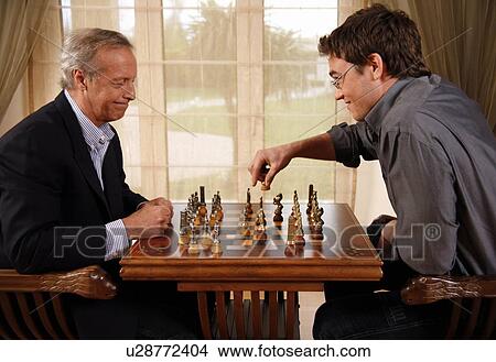 Mature man and younger man playing chess View Large Photo Image Picture - Mature man and younger man playing chess. Fotosearch