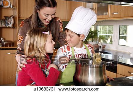 Mother and children cooking View Large Photo Image Stock Image - Mother and children cooking . Fotosearch