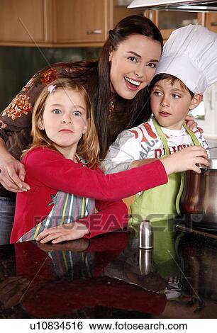 Mother and children cooking View Large Photo Image Stock Photograph - Mother and children cooking . Fotosearch