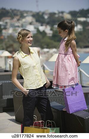 Picture - Mother and daughter with shopping bags. Fotosearch