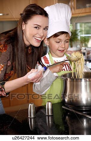 Mother and son cooking spaghetti View Large Photo Image Picture - Mother and son cooking spaghetti. Fotosearch