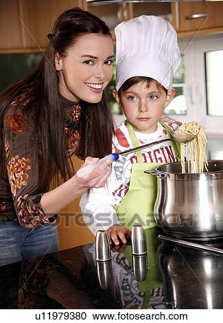 Mother and son cooking spaghetti View Large Photo Image Stock Image - Mother and son cooking spaghetti. Fotosearch