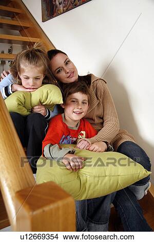 Mother with tired children on staircase View Large Photo Image Picture - Mother with tired children on staircase. Fotosearch