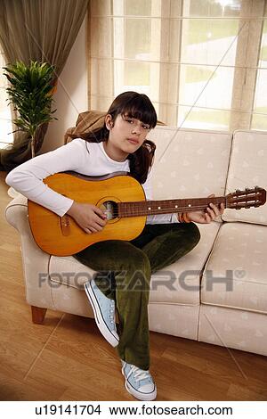 Teenage girl playing the guitar View Large Photo Image Picture - Teenage girl playing the guitar. Fotosearch