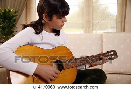 Teenage girl playing the guitar View Large Photo Image Stock Image - Teenage girl playing the guitar. Fotosearch