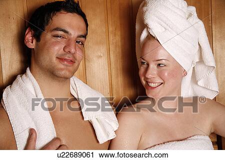 Stock Image - A couple enjoying a sauna together. Fotosearch
