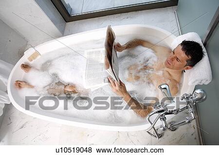 Stock Photo - Man relaxing in bathtub with bubbles. Fotosearch