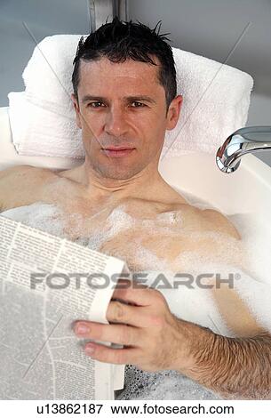 Stock Photo - Man relaxing in bathtub with bubbles. Fotosearch