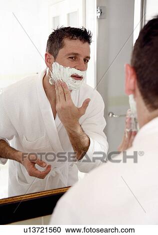 Man shaving in front of mirror View Large Photo Image Stock Image - Man shaving in front of mirror. Fotosearch
