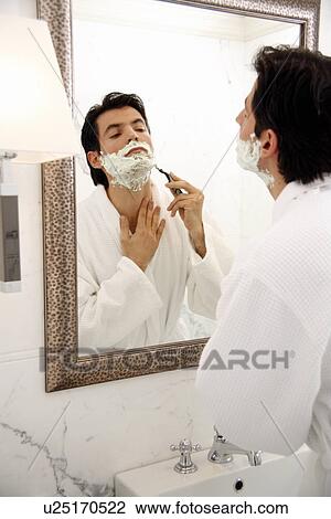 Man shaving in front of mirror View Large Photo Image Stock Image - Man shaving in front of mirror. Fotosearch