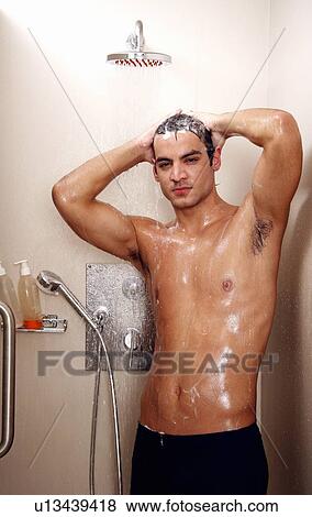Stock Photo - Man taking a shower at the gym. Fotosearch
