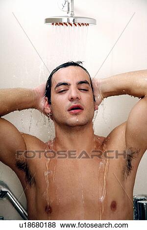 Stock Photo - Man taking a shower at the gym. Fotosearch