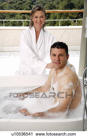 Stock Image - Mature couple having fun in the bathtub. Fotosearch