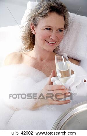 Mature woman enjoying bubble bath View Large Photo Image Stock Image - Mature woman enjoying bubble bath. Fotosearch