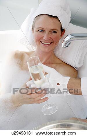 Mature woman enjoying bubble bath View Large Photo Image Stock Image - Mature woman enjoying bubble bath. Fotosearch