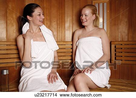 Picture - Two young women enjoying a sauna. Fotosearch