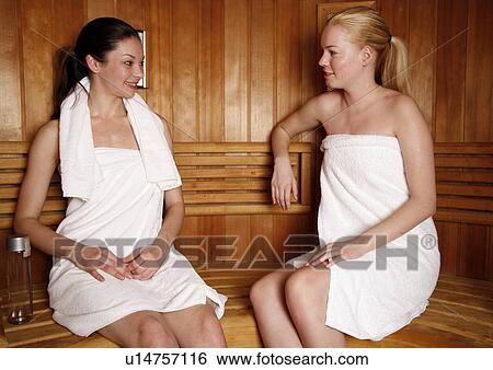 Two young women enjoying a sauna View Large Photo Image Stock Photograph - Two young women enjoying a sauna. Fotosearch