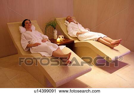 Two young women relaxing at a spa together View Large Photo Image Stock Image - Two young women relaxing at a spa together. Fotosearch