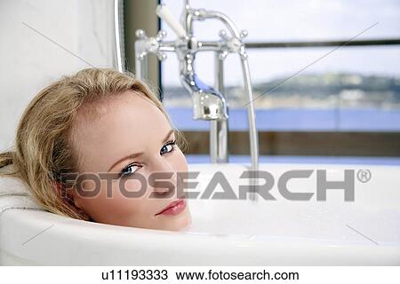 Woman enjoying bubble bath View Large Photo Image Stock Image - Woman enjoying bubble bath. Fotosearch