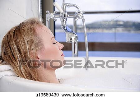 Woman enjoying bubble bath View Large Photo Image Stock Photo - Woman enjoying bubble bath. Fotosearch