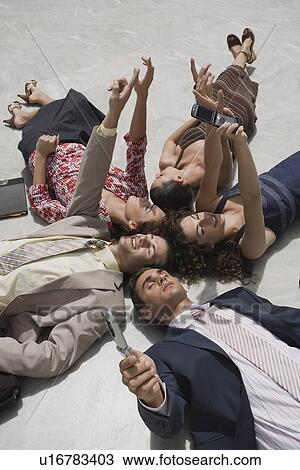 Business people lying on the ground View Large Photo Image Stock Image - Business people lying on the ground. Fotosearch