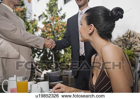 Business people meeting in garden cafe View Large Photo Image Stock Photograph - Business people meeting in garden cafe. Fotosearch