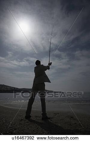Businessman on beach fishing View Large Photo Image Stock Image - Businessman on beach fishing. Fotosearch