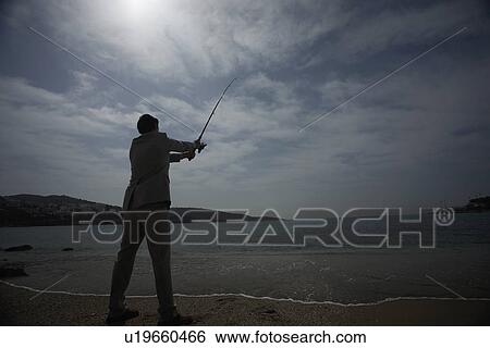 Businessman on beach fishing View Large Photo Image Stock Photograph - Businessman on beach fishing. Fotosearch