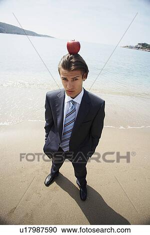 Businessman with apple balanced on his head View Large Photo Image Stock Image - Businessman with apple balanced on his head. Fotosearch
