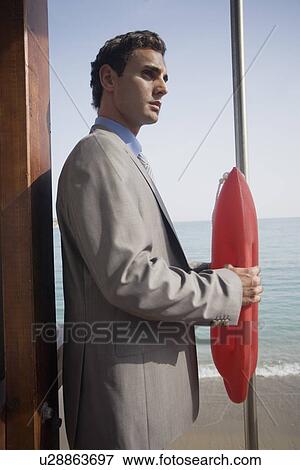 Stock Photo - Businessman with life preserver. Fotosearch