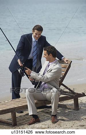 Businessmen on beach fishing View Large Photo Image Stock Photograph - Businessmen on beach fishing. Fotosearch