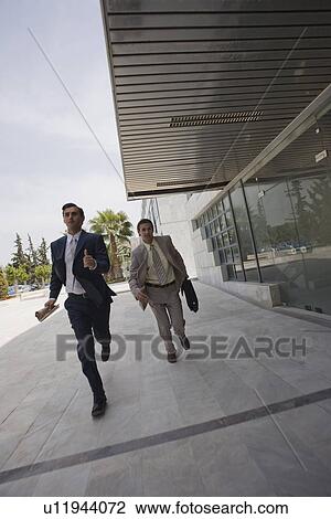 Stock Image - Businessmen running. Fotosearch