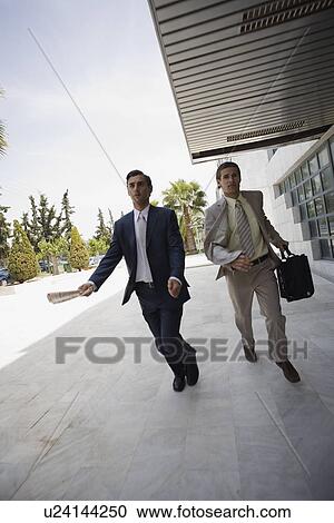 Stock Image - Businessmen running. Fotosearch