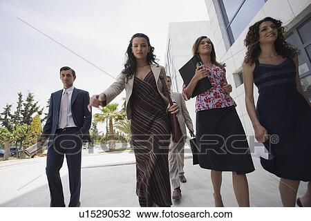 Stock Image - Group of business people walking. Fotosearch