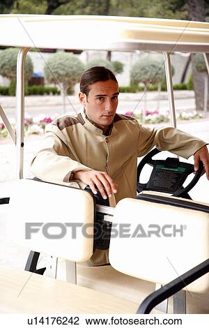 Bellboy driving hotel cart View Large Photo Image Stock Image - Bellboy driving hotel cart. Fotosearch