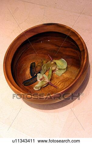 Stock Image - Bowl of water with flowers. Fotosearch