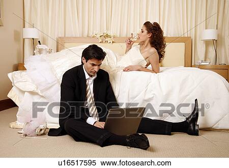 Bride drinking and groom on laptop View Large Photo Image Stock Photography - Bride drinking and groom on laptop. Fotosearch