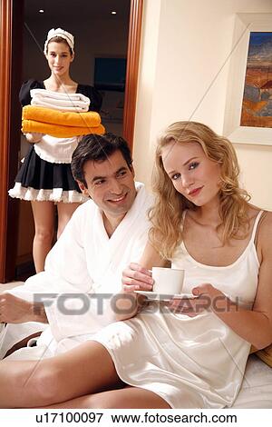 Couple on bed in hotel room View Large Photo Image Stock Photo - Couple on bed in hotel room. Fotosearch