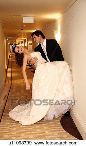 Groom carrying bride into hotel room View Large Photo Image Stock Photo - Groom carrying bride into hotel room. Fotosearch