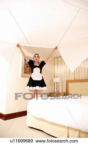 Hotel maid making the bed View Large Photo Image Stock Photo - Hotel maid making the bed. Fotosearch