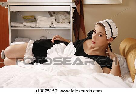 Stock Photo - Hotel maid taking a break. Fotosearch