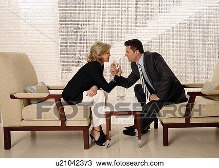 Man and woman sitting in hotel lobby View Large Photo Image Stock Image - Man and woman sitting in hotel lobby. Fotosearch