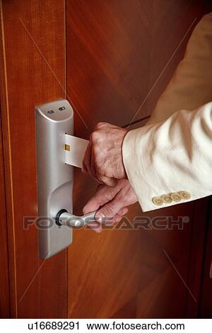 Man putting card key into hotel room door View Large Photo Image Stock Image - Man putting card key into hotel room door. Fotosearch